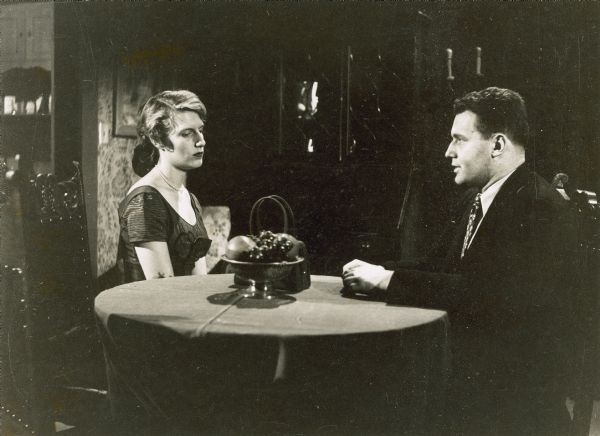 Rod Steiger and Nancy Marchand sitting at a table and talking in a scene from the television production of "Marty." Both are dressed nicely. The production aired on May 24, 1953 as part of the Repertory Theatre series on NBC.