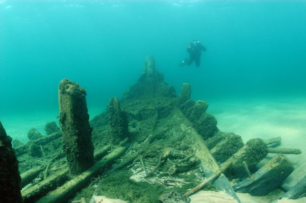 A Wisconsin Historical Society maritime archeologist examines the bow of the steam screw <i>Australasia</i> at the bottom of Lake Michigan.