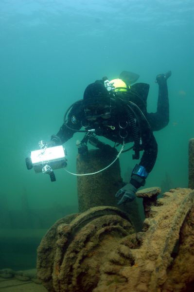 View of an archaeologist documenting the capstan and windlass from the wreckage of the schooner <i>Lucerne</i> at the bottom of Lake Superior.