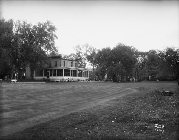 The golf course greens and rear view of the Monona Golf Course clubhouse (aka Nathaniel and Harriet Dean House, built 1856) located at 4718 Monona Drive.