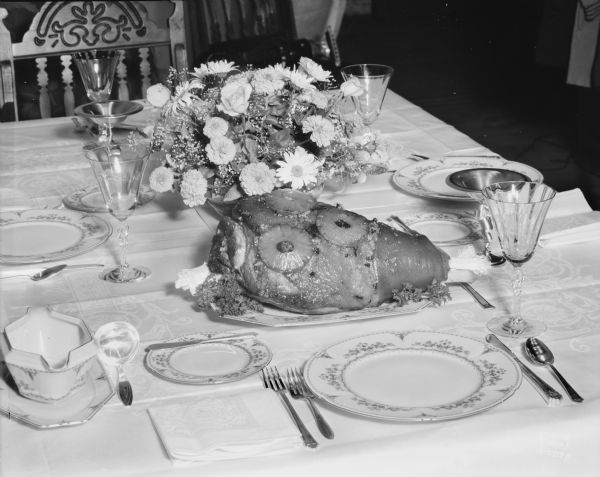 Table set for dinner with Oscar Mayer ham.