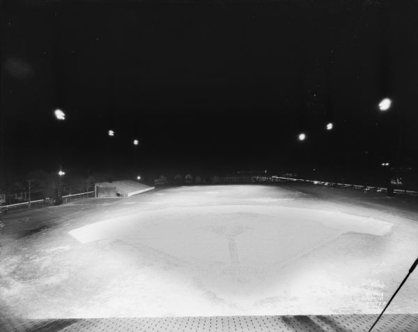 Elevated view of Breese Stevens Athletic Field illuminated at night.