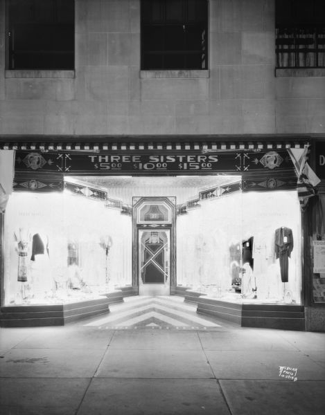 View from sidewalk towards the Three Sisters women's clothing store windows, 27 S. Pinckney Street, Tenney Building, showing art deco decor.