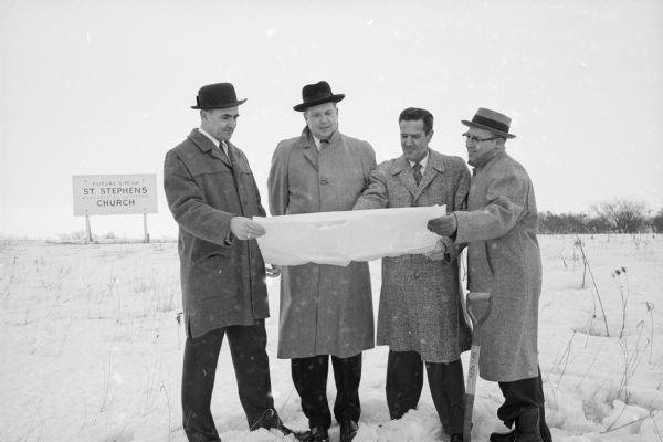 Four men are holding plans for a multi-unit new church on the site for St. Stephen's Evangelical Lutheran Church, 5700 Pheasant Hill Road. Left to right: Jim Lippert, Vince Esser, Russ Mitchell and James Williamson, chair of the building committee. The architects were Gausewitz and Cashin. 