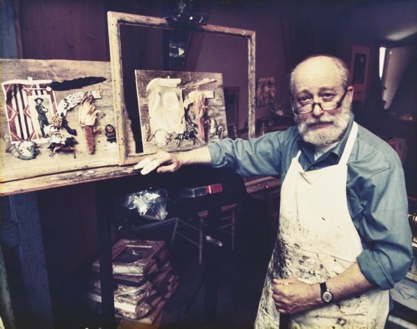 Caption with image reads: "Aaron Bohrod, pictured here in his studio, is the established American master of trompe l'oeil ('fool the eye') painting. This is the technique used in the seven original Bohrod medical still life paintings now owned by the State Medical Society's Charitable, Educational and Scientific Foundation. The philosophy behind his paintings, Mr. Bohrod says, is to 'squeeze the reality out of the object.' He also refers to his technique as magic realism. The artist says: 'The magical quality comes into being through a heightening of the object. Magic realism involves the object itself, plus the artist's interpretation — how he feels about the object, how he perceives it.' And then, each object becomes part of a complex symbolism that he hopes will stimulate thought in the viewer. His philosophy grew from his studies with well-know[sic] urban realist, John Sloan. He admired Sloan's 'ash can' style and eventually he became to Chicago what Sloan was to New York — the portrayer of the shabbier side of city life. From this grew his aim to transfer everyday scenes into meaningful and beautiful works of art. During World War II he became known to millions of Americans for his work as an artist-correspondent of LIFE magazine. Then he used his realistic style to picture the soldier in his environment — digging trenches, unloading barracks bags, writing a letter home. The shift into magic realism came in 1953, when Aaron Bohrod was artist in residence at the University of Wisconsin, Madison, a position he held from 1948 to 1973. During that period his unique style came to have a sizable impact on the American artistic scene."