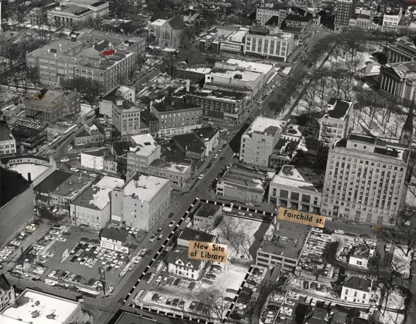 Aerial view of downtown Madison focused on Mifflin and Fairchild Streets with the site of the new Madison Public Library marked. Mifflin Street runs diagonally from top to bottom and Dayton Street runs parallel. The State Capitol is near top right, and State Street runs diagonally from right to left.