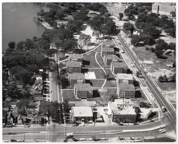 Aerial view of the Sampson Plaza apartment complex on West Washington Avenue, with Proudfit Street running along the bottom. Neighborhood House can be seen near the top on West Washington Avenue. Meriter Hospital is in the top right corner. Monona Bay on Lake Monona are at top left.