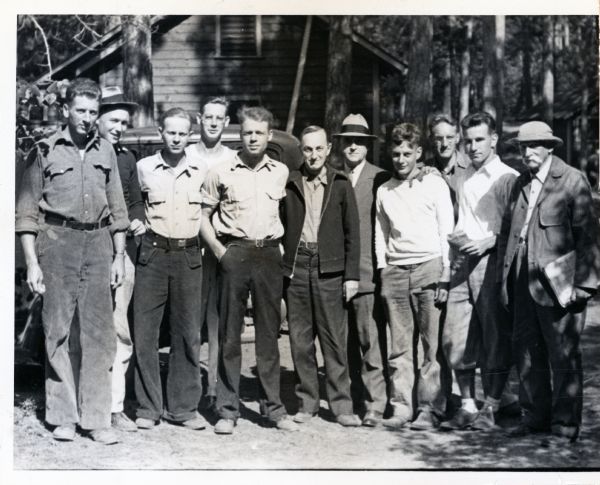 A group of scientists posing together for a group portrait. E.A. Birge is the first man on the right, and Chancey Juday is in the center of the group, sixth man from the right.