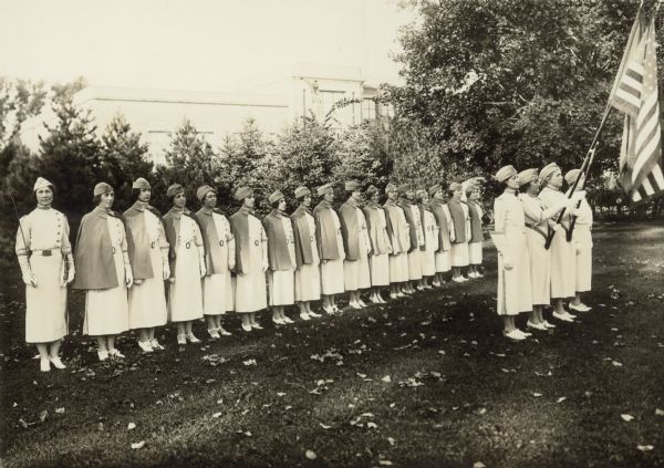 Group of women in formation. List of women on back: Lois Hart, Louise Onsgard, Alva Bergor, Laura Grey, Margaret Smith, Mrs. Larson, Edna Korth, Mary King, Alma Omerening, Gladys Phelps, Mrs. Lynaugh, Emily Zapata.