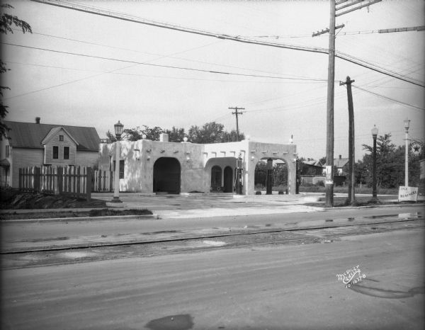 New Texaco Service Station at 2846 Atwood Avenue, owner Joseph M. Setzer. Railroad tracks are running down the center of the street.