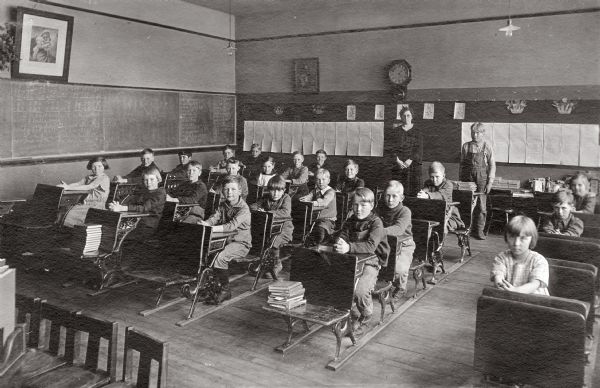 Students sitting in a classroom in the Clear Lake School. Gaylord Nelson, later governor of Wisconsin and a United States senator, is sitting at the front of the third row from the left.