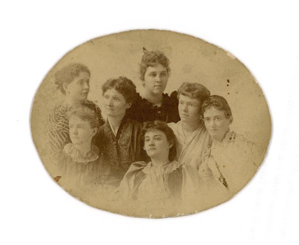 An oval portrait of Gwyneth King Roe with Emilie Neidlinger, Emily Bishop-Netha, Dorothy Bishop, Adalaide (Adelaide) Jones, Gertrude Bishop, and Lucia Benedict. "Calling ourselves The Muses."