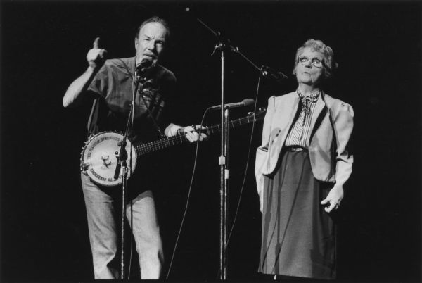 Pete Seeger and Florence Reece at Highlander Benefit Concert at Bijou Theater. The inscription written on Seeger's banjo reads: "This Machine Surrounds Hate and Forces it to Surrender".