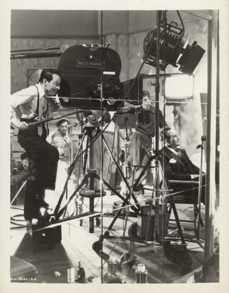 Film director Frank Borzage and camera operator Joseph Biroc, along with other members of the film crew, are seen in the reflection of mirrors on the set of the 1937 film "History Is Made at Night".