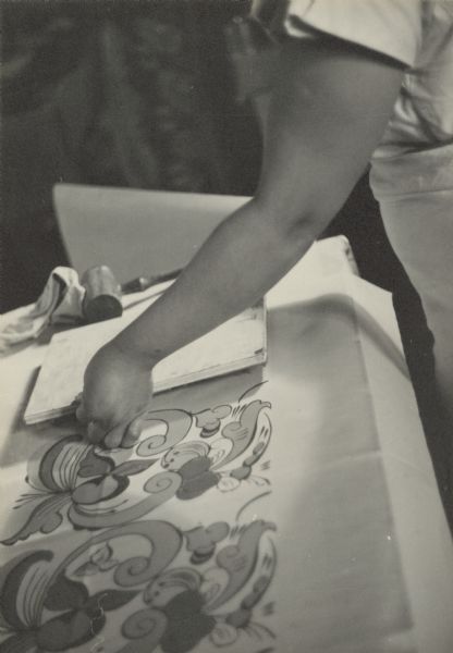 Caption reads: "The finished block is inked and carefully placed upon the cloth".