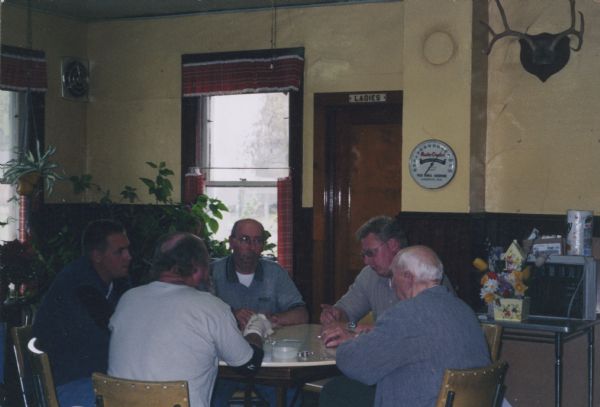 Five men are sitting around a table inside Wittnebel's Tavern. Left to right are: Tom Wittnebel, Luke Wittnebel (Jim's son), Jim Wittnebel (Jim's son), Ryan Wittnebel (Jim's son) and Roy Wittnebel.