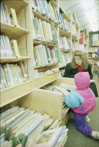 Diane Wells helps her daughter Stephanie pick out books at the Dane County Library Service Bookmobile.