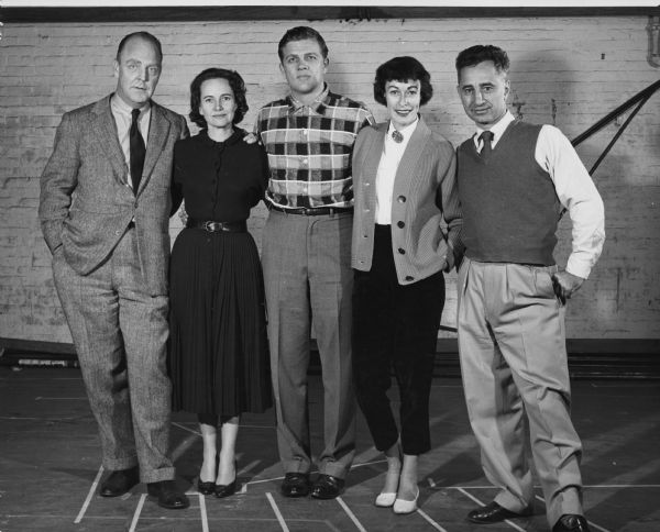 Three men and two women pose together on a stage. Caption reads: "l to r: William Inge, Teresa Wright, Pat Hingle, Eileen Heckart, Elia Kazan. Photographed during rehearsals of 'The Dark at the Top of the Stairs'".