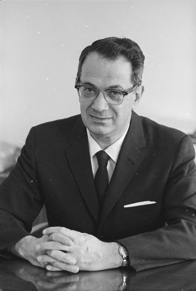 Portrait of Gordon Sinykin sitting behind a desk.