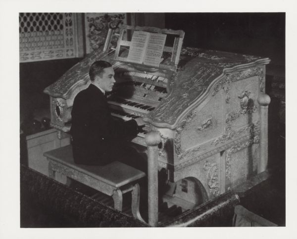 A young man is sitting at an organ. Caption reads: "Al Gullickson, theater and radio organist, about 1926. He dedicated theater organs for the Barton Organ Co, Oshkosh."