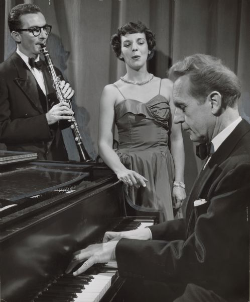 Three performers are on stage together: a man playing a clarinet, a woman singing, and a man playing a piano. Caption reads: "<b>A concert trio performed</b> at the Milwaukee Art institute Thursday night. Their appearance was in connection with the institute's current exhibition of music and art. From left are James Morton, 2220 E. Jarvis st.; Gloria Rodriguez, 2524 N. Lake dr., and Erving Mantey, 1041 E. Ogden av."