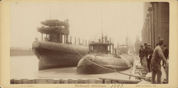 Captain Abe McDougall's whaleback boat, docked at the American Steel Barge Company. Text at bottom right of card reads: "West Superior, Wis."