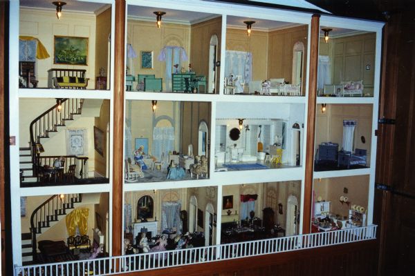 A large twelve room, three-story, fully decorated dollhouse located in the main lodge at Forest Lodge.