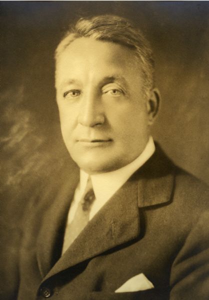 Sepia tone portrait of Theodore Wright Griggs, (9/3/1872 - 2/13/1934), dressed in a suit with a handkerchief in the breast pocket.