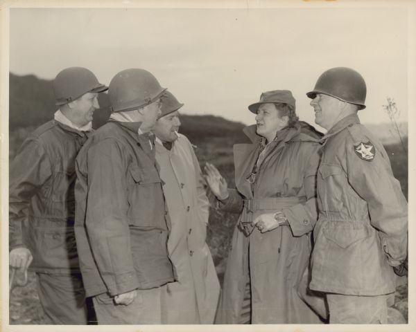 Text on back of photograph reads: "Esther Van Wagoner Tufty interviewing four members of a congressional delegation fact-finding mission during Korean War — at the DMZ."