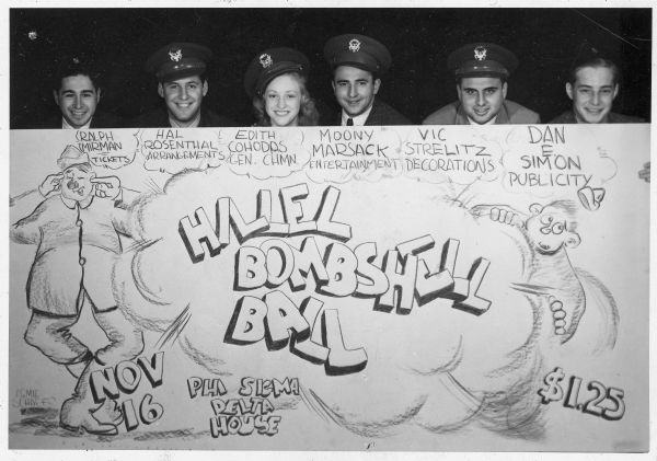 Six people posing behind a handmade poster for the Hillel Bombshell Ball. They are identified on the poster as Ralph Mirman, Hal Rosenthal, Edith Cohodas, Moony Marsack, Vic Strelitz, and Dan E. Simon.