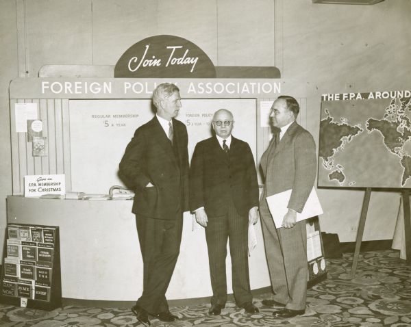 From left to right, are: James G. McDonald, chairman, Sir Alfred Zimmern, and Raymond L. Buell, member of the board of directors of the FPA. They stand together in the lobby of the Hotel Astor during the 20th Anniversary celebration of the Foreign Policy Association.