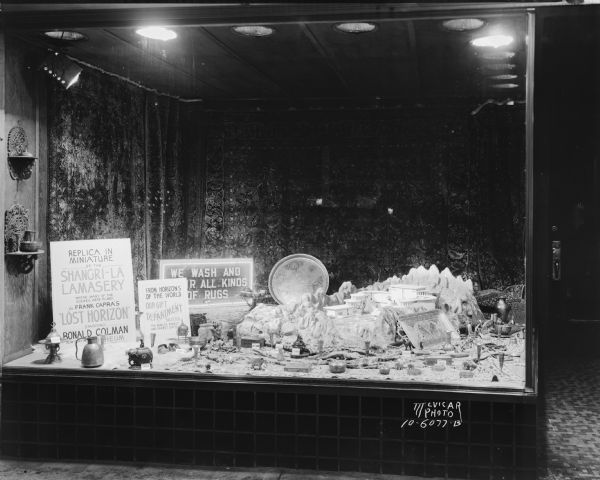 Window display of a miniature replica of Shangri-la lamasery where many scenes were filmed for Frank Capra's movie "Lost Horizon", and oriental gift items, at Oriental Rug Galleries, 422 State Street.