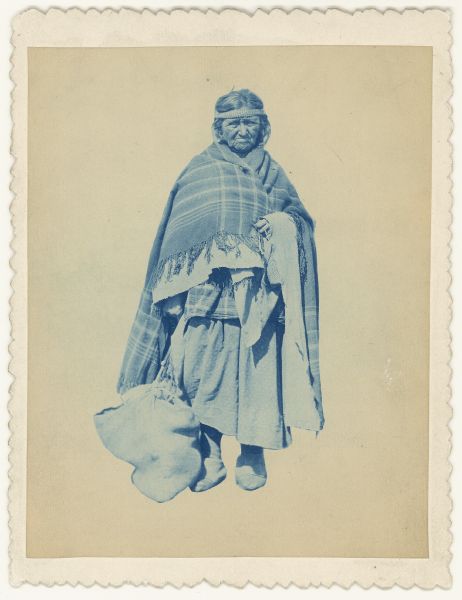 A cyanotype portrait of Mary Crane, a Ho-Chunk Indian woman. She has a blanket around her shoulders and is wearing a headband. 