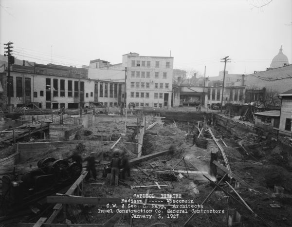 Capitol Theatre, at 211 State Street. View of the foundation excavation from the construction house roof toward State Street. The Wisconsin State Capitol is in the background on the right.