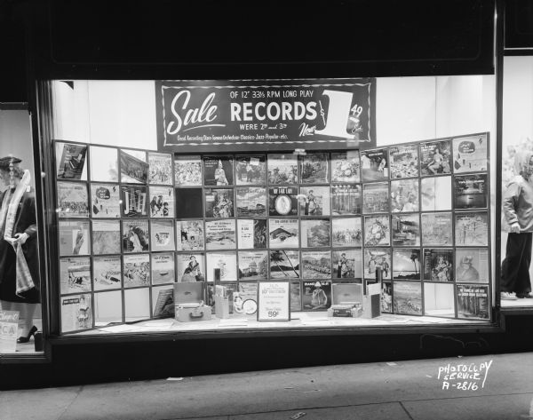 Hill's Department Store, 202 State Street, display window featuring a sale on 12" 33 1/3 RPM long play records.