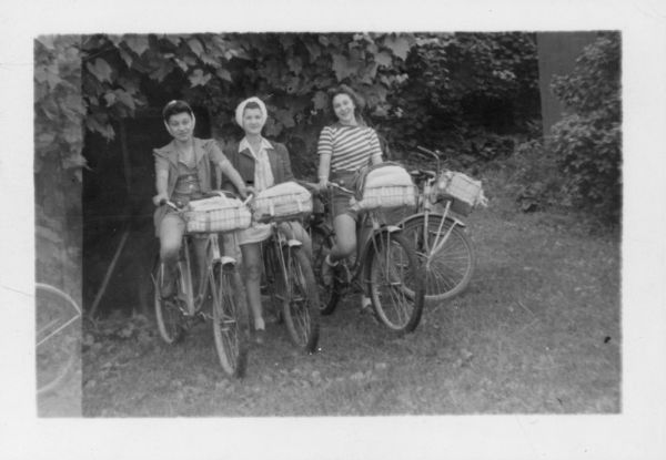 Katy La Bruzzo, Tina Fedele, and Catherine Gandolph posed with their bicycles at the Lake Mills Hostel on their bicycle trip with the Neighborhood House American Youth Hostel group.