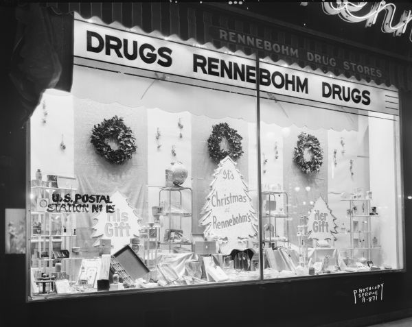 Display window at Rennebohm Drug Store #2, 204 State Street, showing "His Gifts" and "Her Gifts" for Christmas. The sign painted on the window on the left reads: "U.S. Postal Station No. 15."
