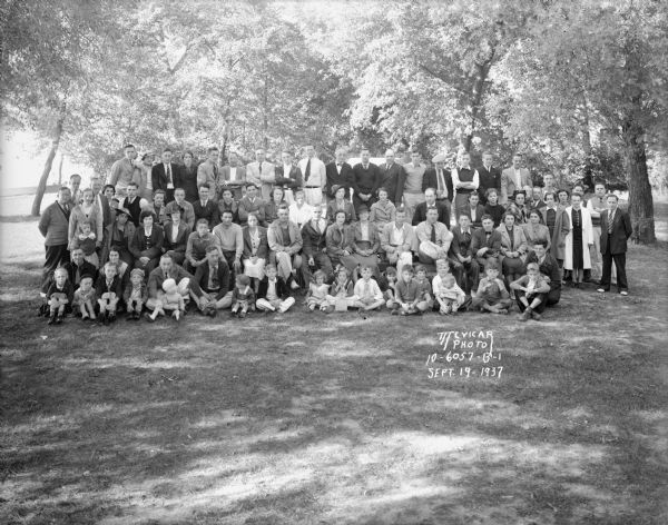 Group portrait of Kayser Motors employees and their families on a picnic at Burrows Park.