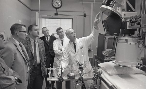One of four United Community Chest (United Way) panel groups tours the McArdle Laboratory at the U.W. Hospitals to see how United Givers funds are used by the lab. Shown (left to right) are Robert C. McMurray, 418 Few St.; Gordon Rice, 300 Lakewood Blvd.; Bernhard Mautz, Jr., 906 McBride Rd.; John Reynolds, 2707 Colgate Rd.; Dr. Charles Crumpton, 9 Cambridge Rd., President of the Wisconsin Heart Assn; and Dr. George C. Rowe, 5 Walworth Ct.
