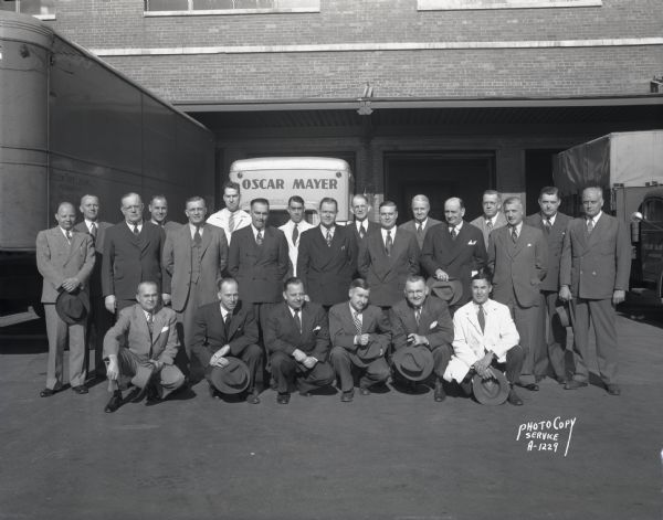 Group portrait of Oscar Mayer Company salesmen in front of the loading dock, 910 Mayer Avenue.