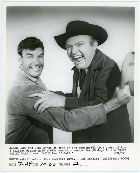 Actors James Best and Gene Evans hold on to each other while smiling and laughing in a publicity photograph for the TV show <i>Death Valley Days</i>