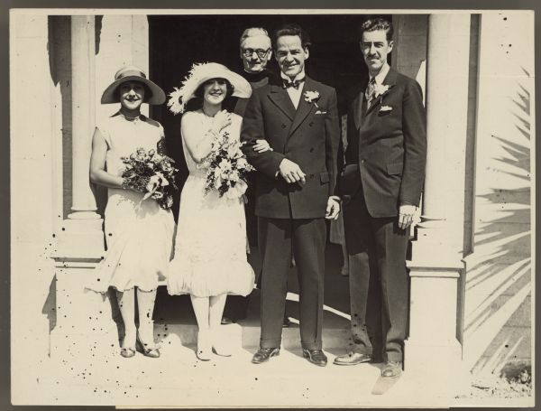 Photograph of Helen Ferguson and William Russell outside the church on their wedding day with the minister, a bridesmaid and best man.  